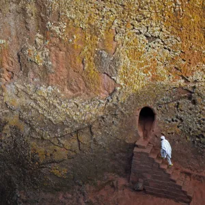 Orthodox Christian walks into one of 11 monolithic rock-cut churches, ahead of Orthodox