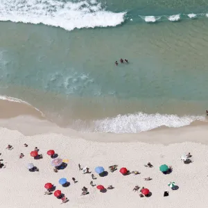 People enjoy the Barra da Tijuca beach in Rio de Janeiro