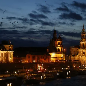 People stroll along the embankment of the Elbe river in Dresden