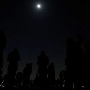 People wait to watch a lunar eclipse at the open air skydeck of Roppongi Hills Tower in