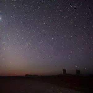 The planet Venus is seen in the night sky over rocks in the White Desert north of