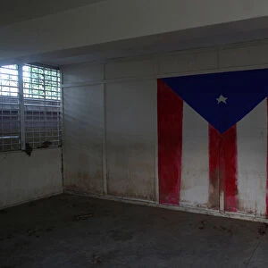 The Puerto Rican flag is seen on the wall of a class room of a shut-down elementary