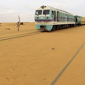 Railway tracks are covered by sand as a result of desert encroachment at Ogrein Railway