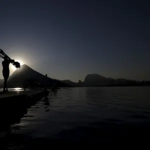 A rowing athlete carries paddles ahead of training session at the World Rowing Junior