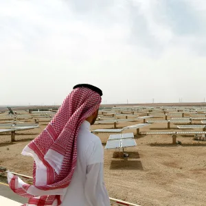 Saudi man looks at the solar plant in Uyayna, north of Riyadh