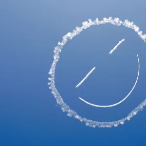 A sky writer draws a smiley face in the sky at start of Los Angeles County Air Show