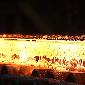 A slab of steel rolls down the line at the Novolipetsk Steel PAO steel mill in Farrell