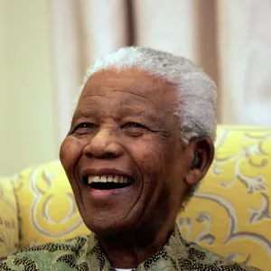 Former South African President Nelson Mandela laughs during an interview with the