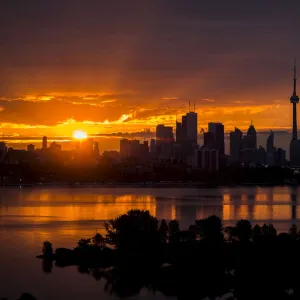 The sun rises over the skyline in Toronto