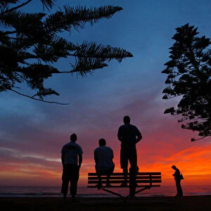 SURFERS OBSERVE THE WAVES AT SUNRISE IN SYDNEY