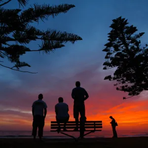 SURFERS OBSERVE THE WAVES AT SUNRISE IN SYDNEY