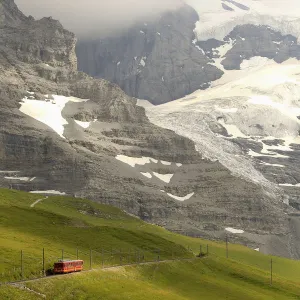 Tourists leave a train of the Jungfraubahn railways at the Kleine Scheidegg station