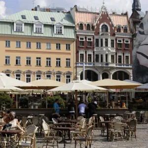 Tourists rest at the open-air cafe in downtown Riga