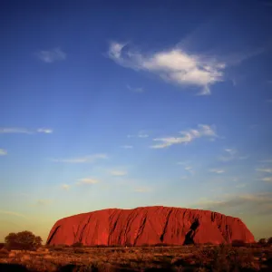 Uluru is lit by the setting sun in the Northern Territory in central Australia