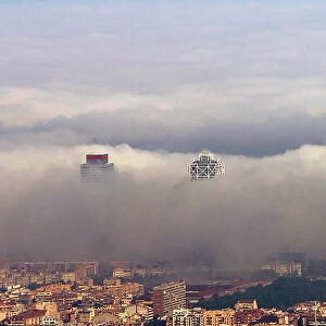 An unusual fog settles over Barcelonas city coastline