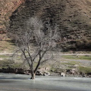 A view of Mailuu-suu river near the town of Mailuu-suu