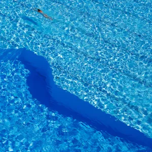 A woman swims in a public pool as temperatures reach new record highs in Hanau