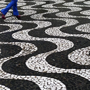A woman walks over patterned paving in central Porto Alegre during the 2014 World