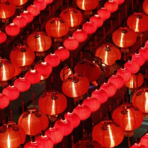 A worker changes light bulbs ahead of Chinese New Year celebrations at the Thean Hou