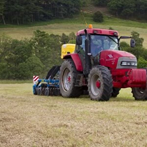 Contractor with McCormick MC120 tractor and ERTH Agriseeder precision slot seeder