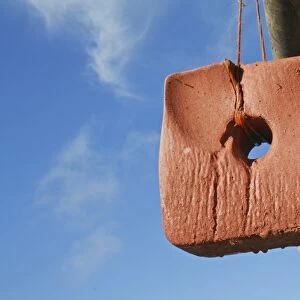 Horse mineral block hanging from fence in paddock, Suffolk, England, October