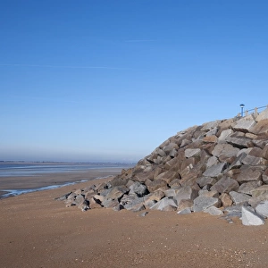 Sea defence boulders and houses, St. Martin de Brehal, Manche, Normandy, France, December