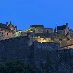 View of castle on volcanic plug illuminated at night, Edinburgh Castle, Edinburgh, Scotland, July