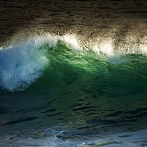 crashing wave with translucent green and spray