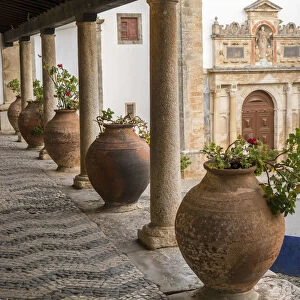 Europe, Portugal, Obidos. Ceramic pots adorn a ledge along a building