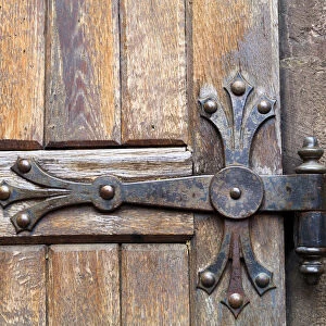 Europe, Romania. Brasov. Detail of church exterior. Wood Door hinge