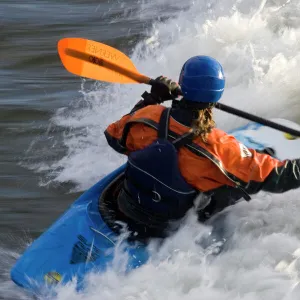 Kayakers in playboat kayaks in Brennans Wave surf in the Clark Fork River in