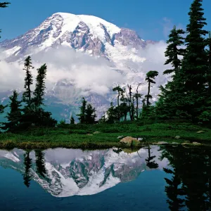 Mount Rainier relected in a mountain tarn (pond), Pinnacle Peak, Tatoosh Range, Mount