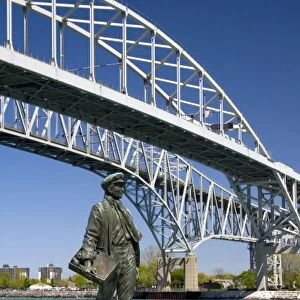 A statue of Thomas Edison by local artist Mino Duffy sits below the Blue Water Bridge along the St
