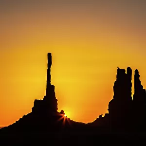 USA, Arizona, Monument Valley Navajo Tribal Park. Silhouette of formations at sunrise