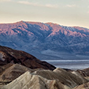 USA, California, Death Valley National Park, Panoramic view of moon setting at sunrise