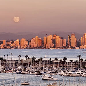 USA, California, San Diego, Full moon rises over boats and city on San Diego Harbor