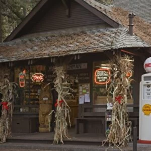 USA, Oregon, Camp Sherman. Two vintage gasoline pumps displayed in front of store
