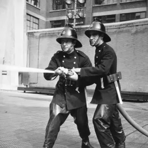 Firefighters taking part in a hose training drill