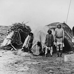 APACHE CAMP, 1882. Apache Native Americans in camp, one (right) wearing a partial