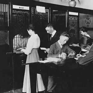 BANK, 1910. Students participating in a school savings program at an American bank