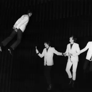 THE BEATLES, 1964. The Beatles fly above the stage during a rehearsal for the Night of 100 Stars charity show at the London Palladium, 1964. Left to right: Ringo Starr, Paul McCartney, John Lennon and George Harrison