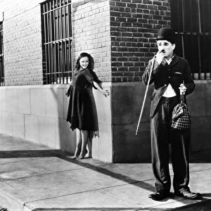 CHAPLIN: MODERN TIMES, 1936. Charlie Chaplin and Paulette Goddard in a scene from the film, Modern Times, 1936