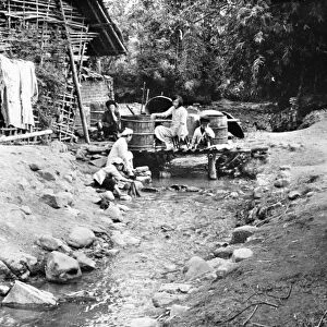 CHINA: CHEFANG, c1940. People washing their clothes in a stream, at the family s