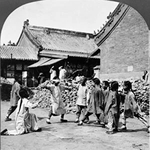 CHINA: PEKING, c1924. Chinese children playing blind mans bluff outdoors with