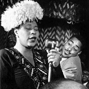 ELLA FITZGERALD (1917-1996). American singer. Performing on stage with Dizzy Gillespie, 1947