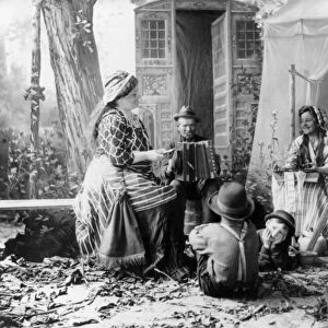 GYPSYIES, c1902. Happy Romanies. A staged rendition of musicians in a gypsy camp