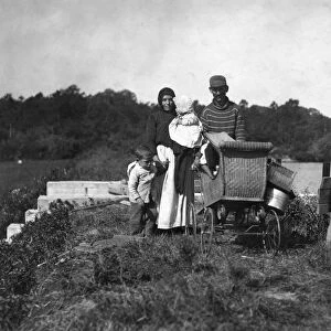 MIGRANT FAMILY, 1911. A family of migrant berry pickers on their way to work at Swifts Bog