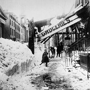 NEW YORK: BLIZZARD OF 1888. A man shovels snow beneath the collapsed awning of