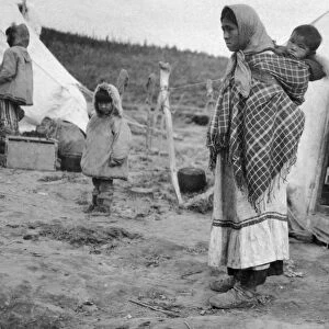 NORTHWEST TERRITORIES, 1921. A mother and child, possibly of the Gwich in people