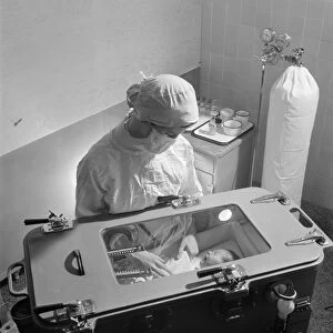 NURSING, 1942. A nurse caring for a premature infant in an incubator. Photograph by Fritz Henle
